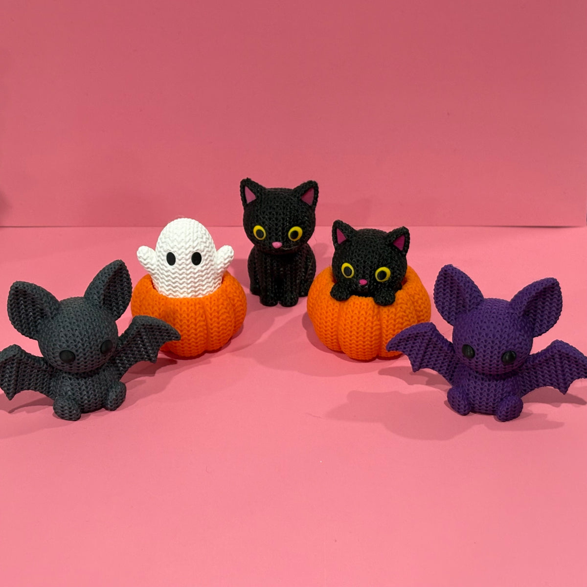 Halloween Knitted Pals 3D printed collection featuring grey and purple bats, a sitting black cat, a pumpkin cat and a pumpkin ghost